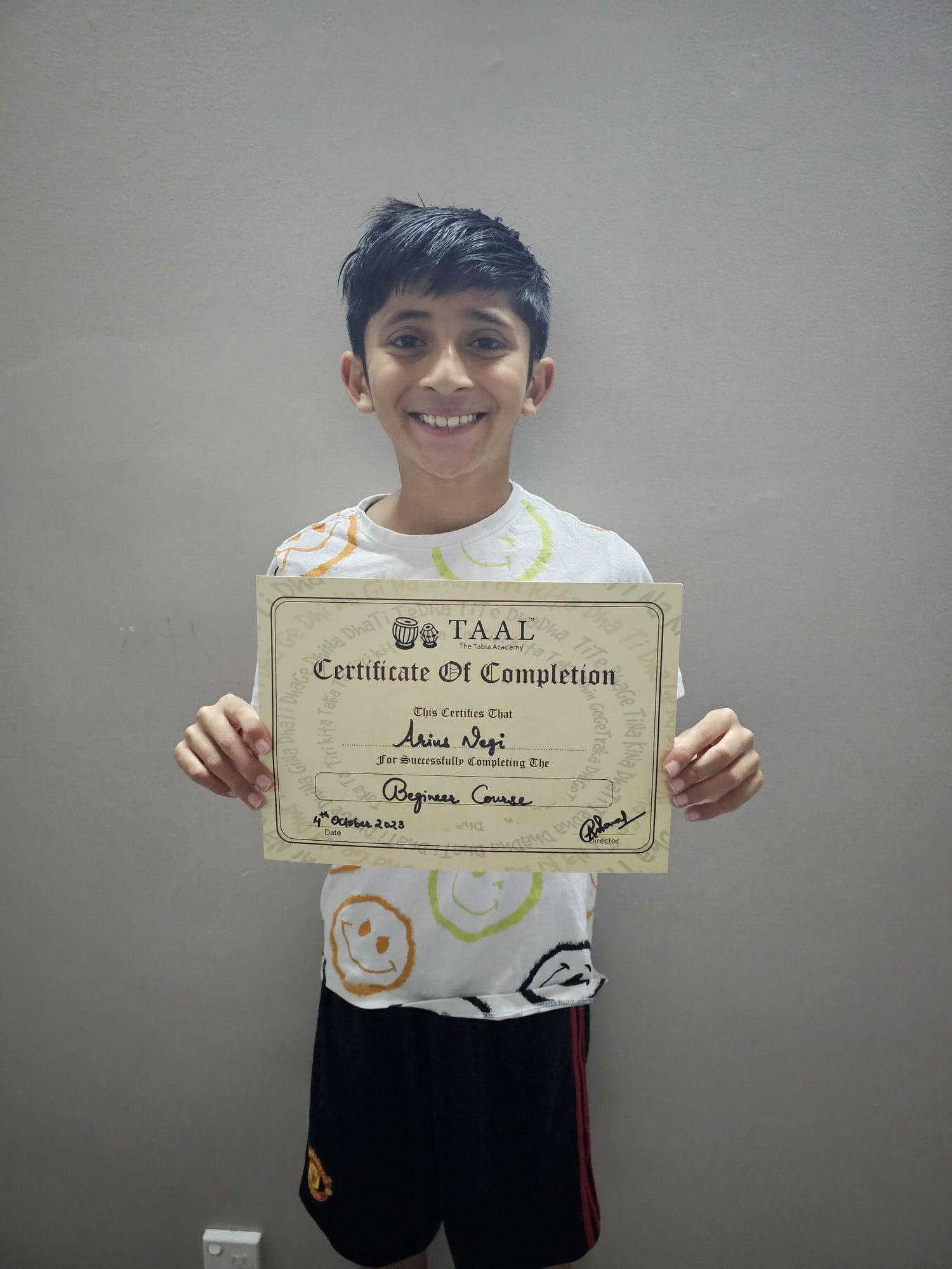 Student holding his TAAL beginner course completion certificate