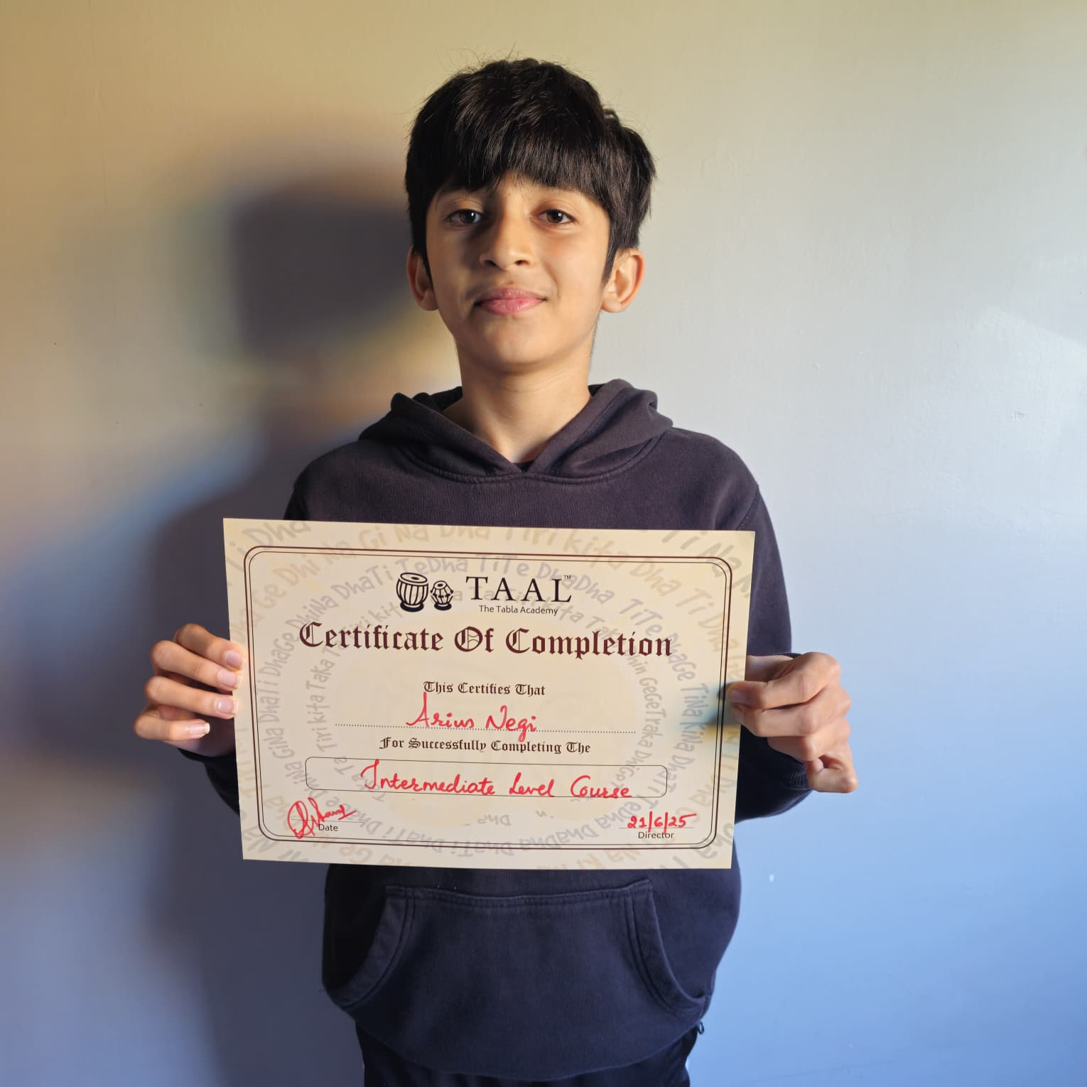 Student holding a TAAL intermediate level certificate of completion